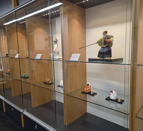Display of Hakata Ningyo clay dolls in glass cabinets